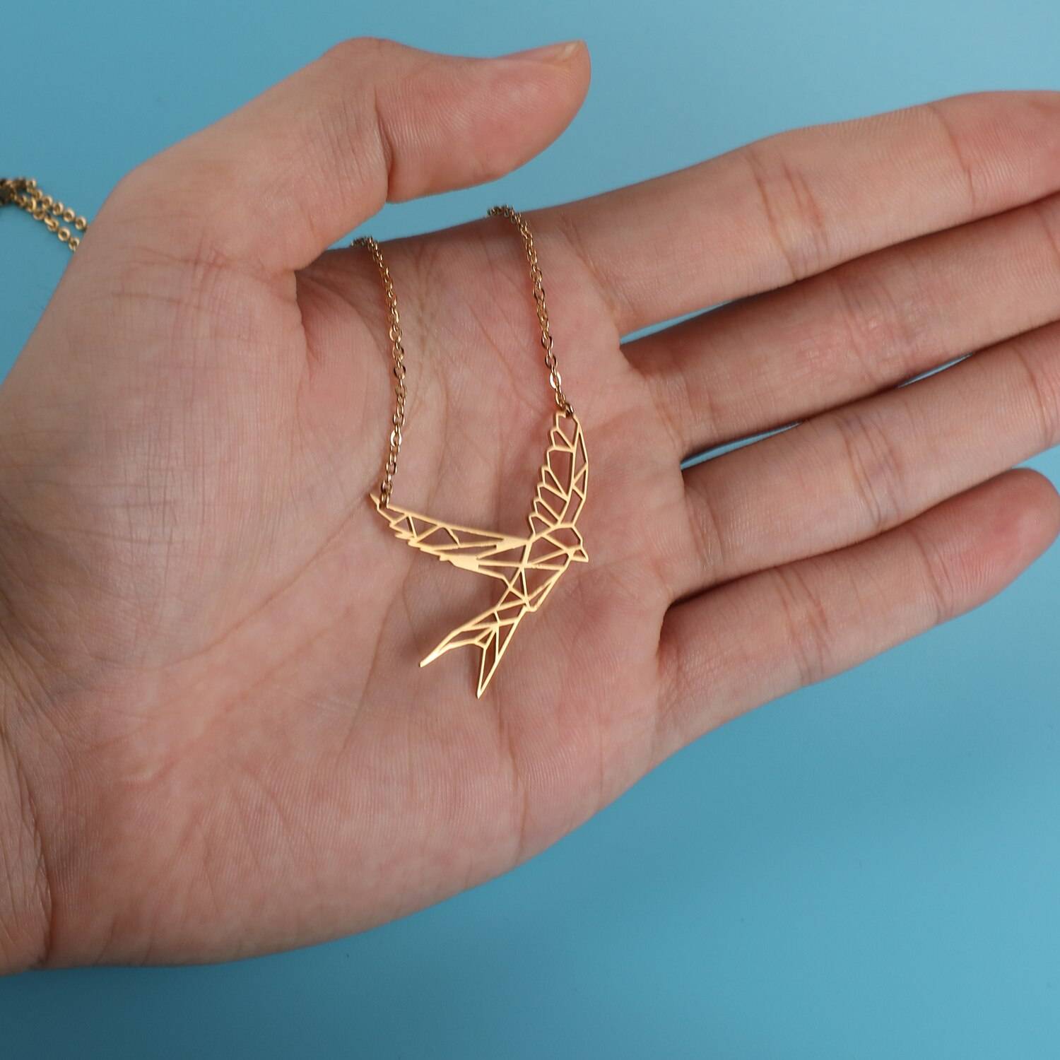 Soaring Seagull Origami Necklace in hand