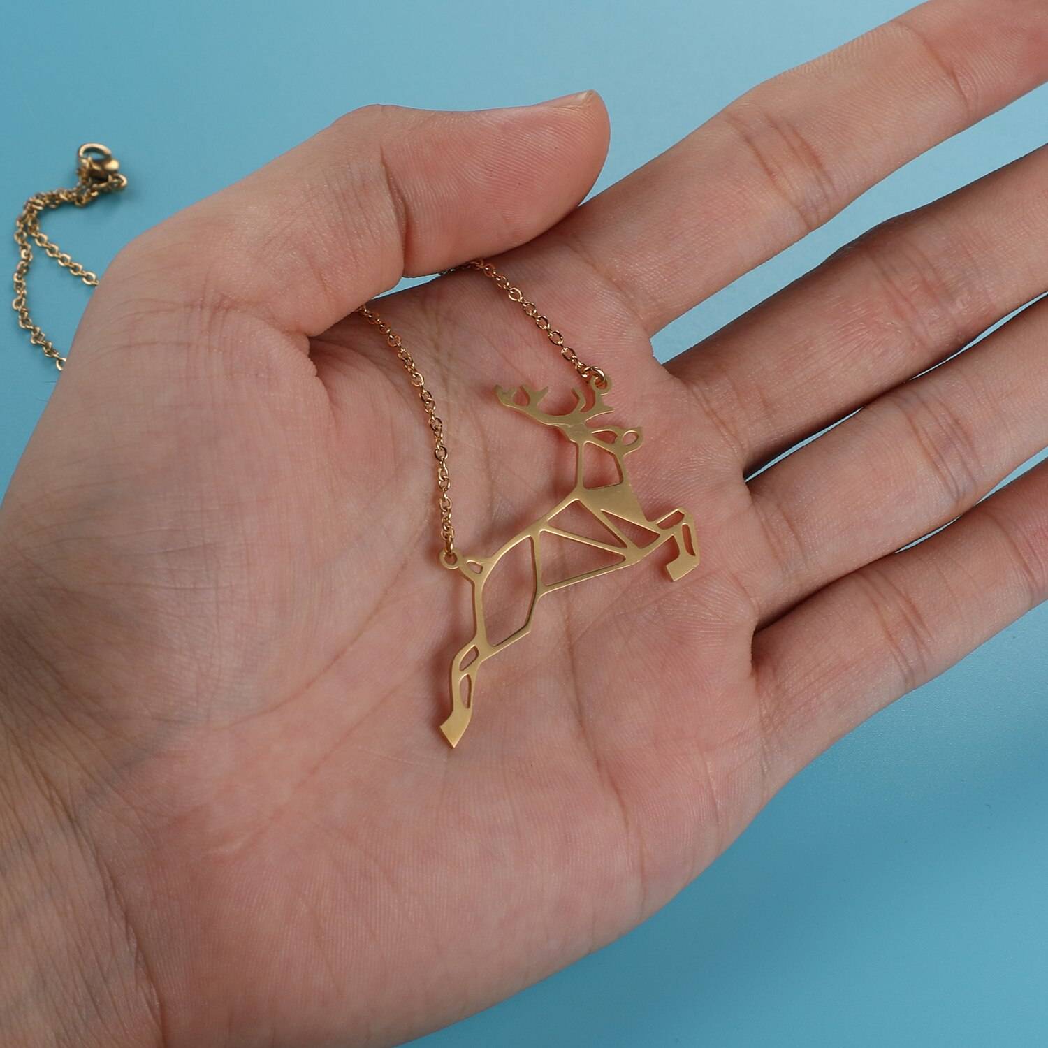 Galloping Deer Origami Necklace on hand