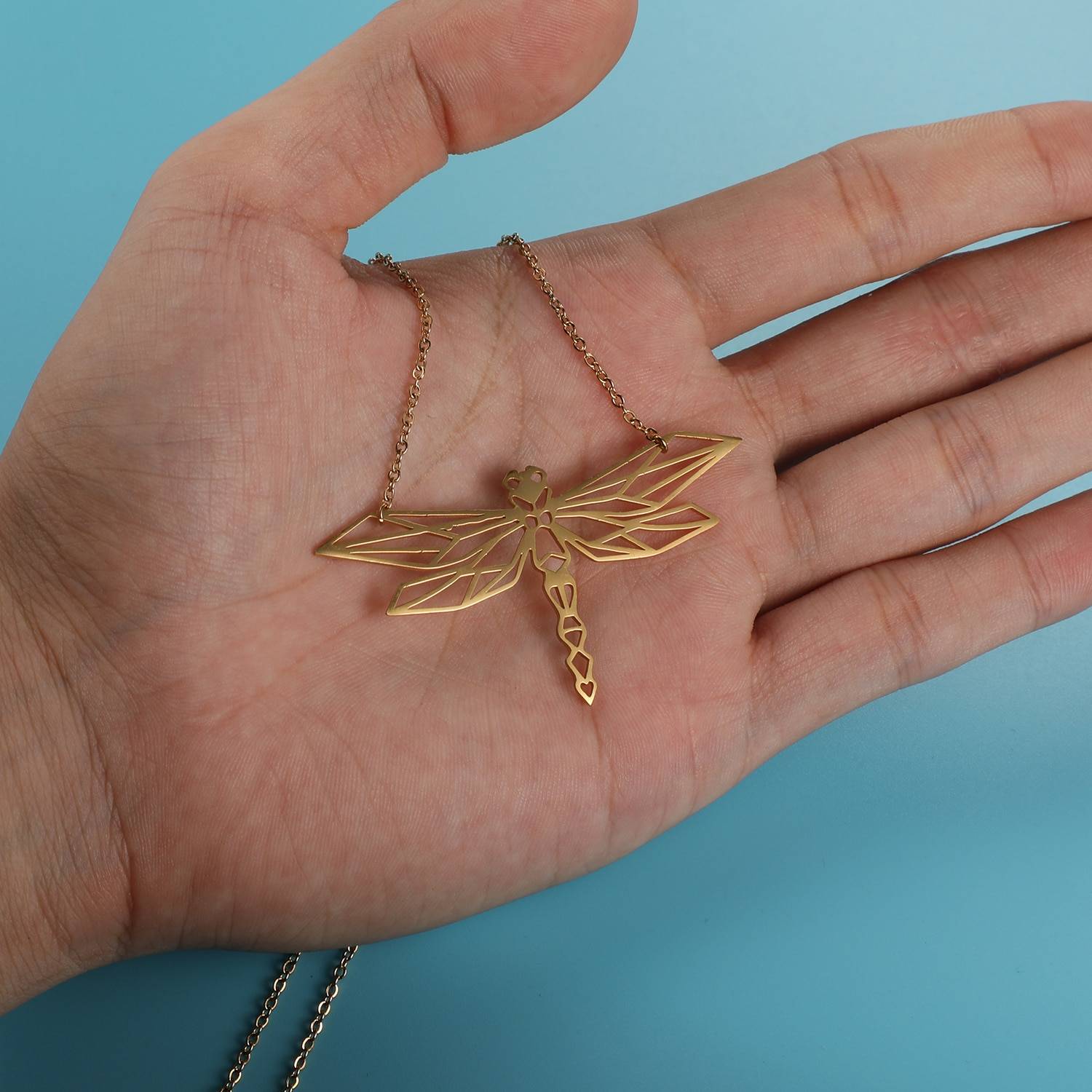 Dancing Dragonfly Origami Necklace in hand