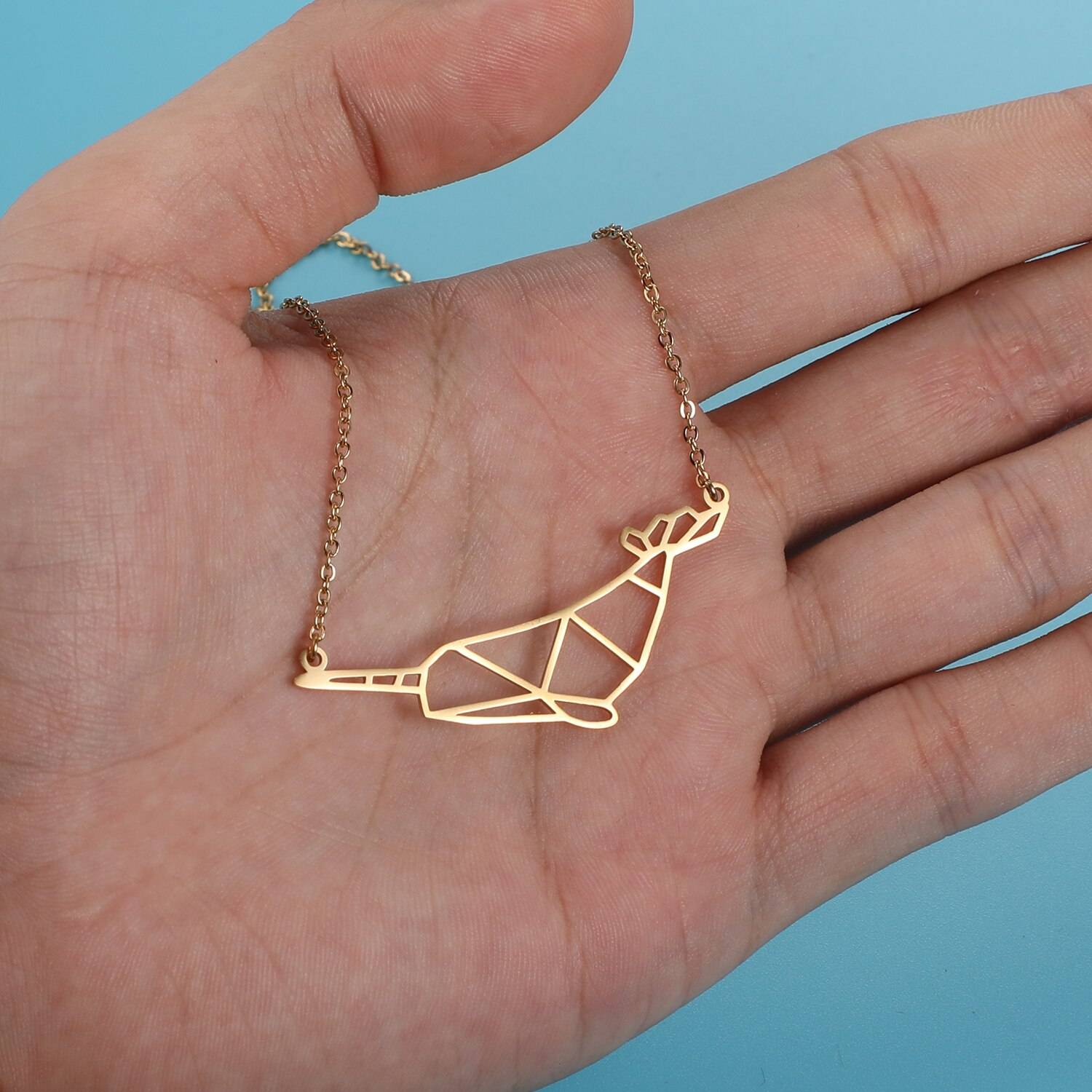 Magical Narwhal Origami Necklace on hand