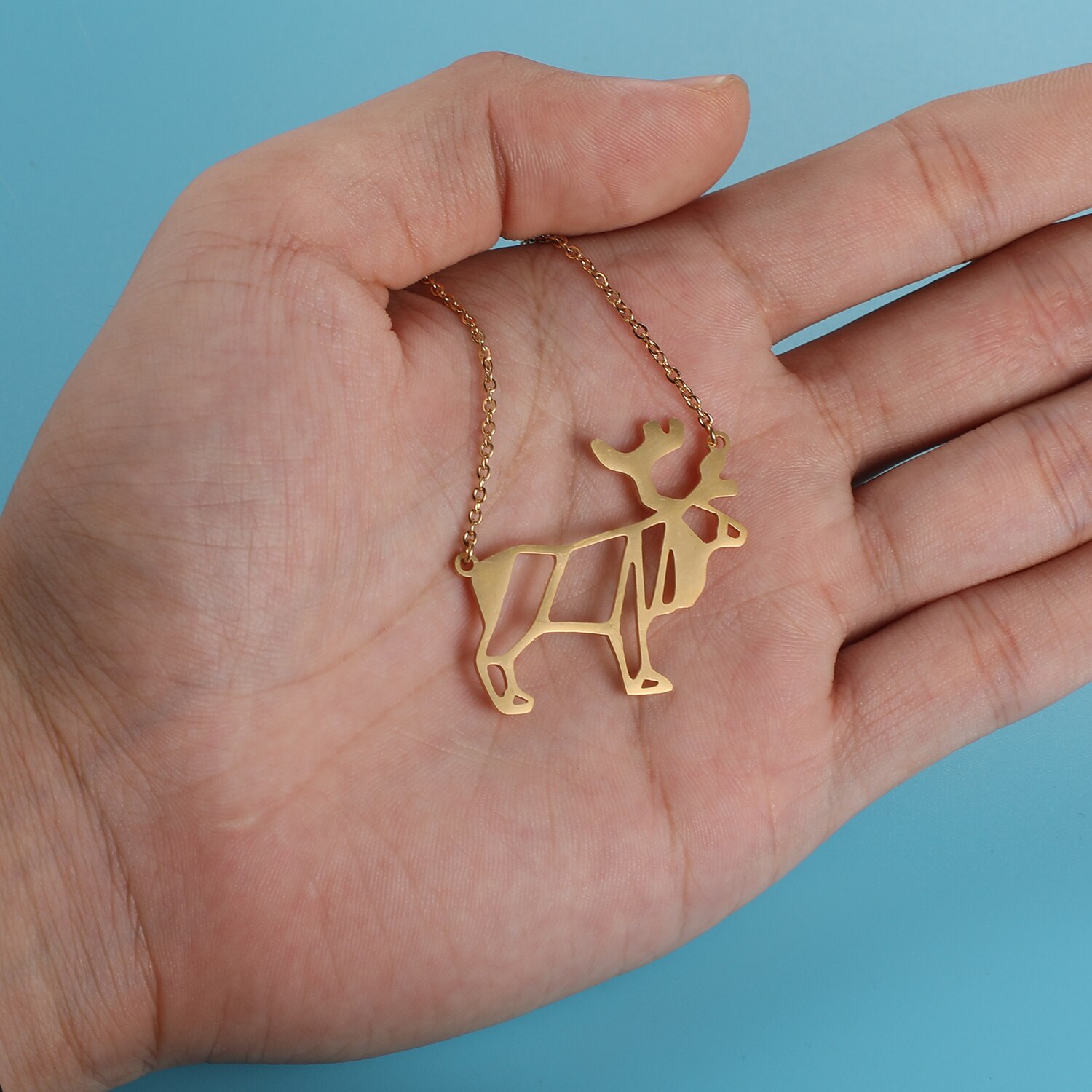 Stately Elk Origami Necklace on hand